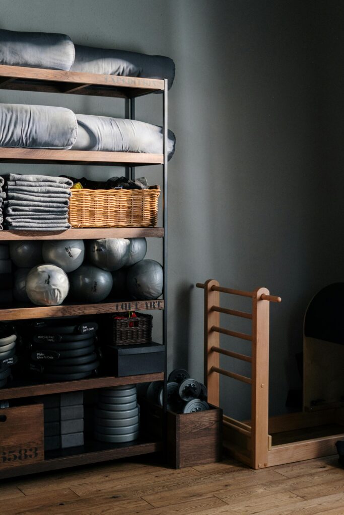 What to Expect Neat arrangement of gym equipment and yoga mats in a modern fitness studio.